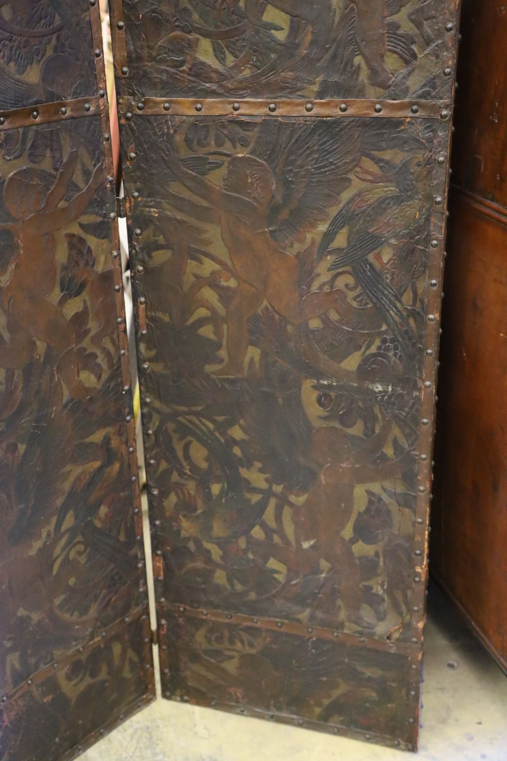 A Dutch leather four fold screen, c.1860, each panel 49cm x 203cm